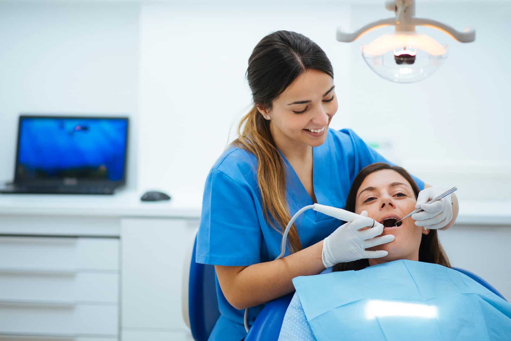 dentist cleaning patient teeth at exam in Bowling Green, KY